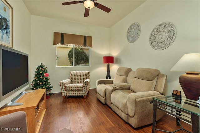 living room featuring ceiling fan, lofted ceiling, and dark wood-type flooring