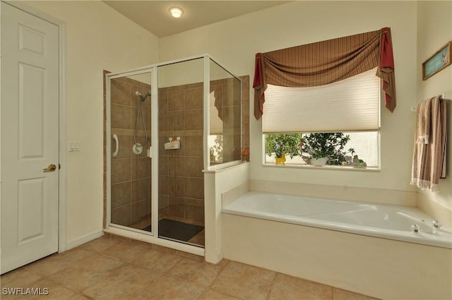 bathroom featuring tile patterned flooring and independent shower and bath