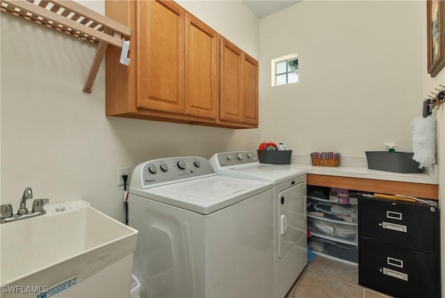 washroom with washer and dryer, light tile patterned flooring, cabinets, and sink