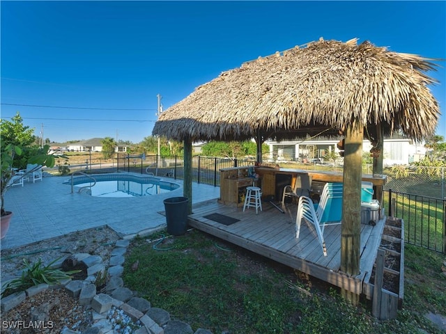 view of swimming pool featuring exterior bar and a deck