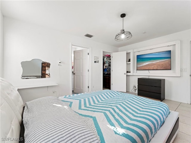 bedroom featuring a closet and light tile patterned floors