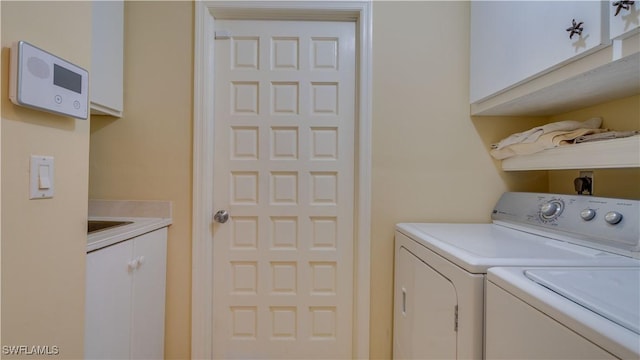 laundry room featuring cabinets and separate washer and dryer