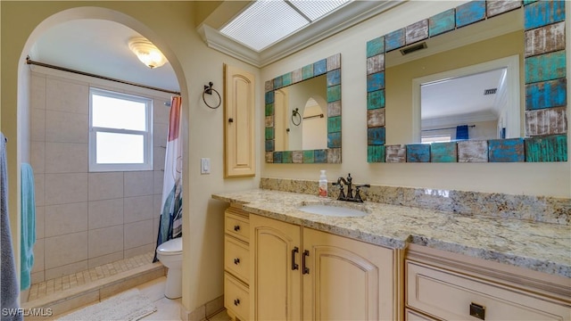 bathroom with vanity, curtained shower, toilet, and crown molding