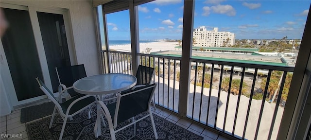 balcony with a water view and a beach view