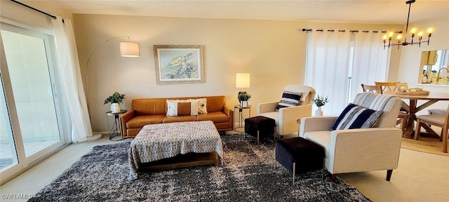 living area featuring light carpet, a chandelier, and a wealth of natural light