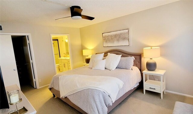 carpeted bedroom featuring a textured ceiling, connected bathroom, and ceiling fan