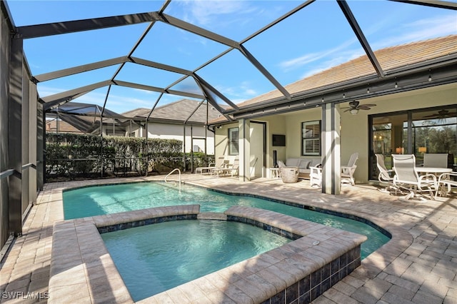 view of swimming pool featuring a lanai, ceiling fan, a patio area, and an in ground hot tub