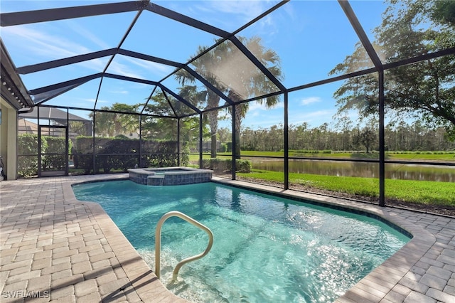 view of pool featuring glass enclosure, an in ground hot tub, a patio area, and a water view