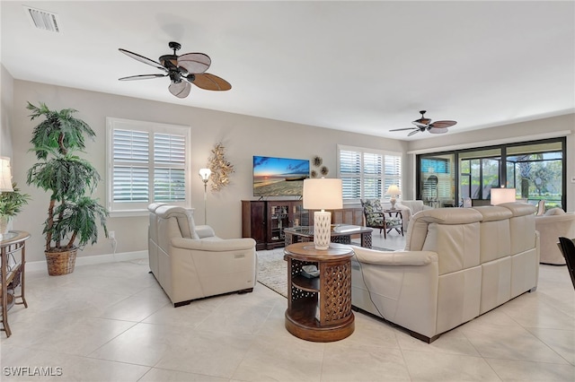 tiled living room with ceiling fan