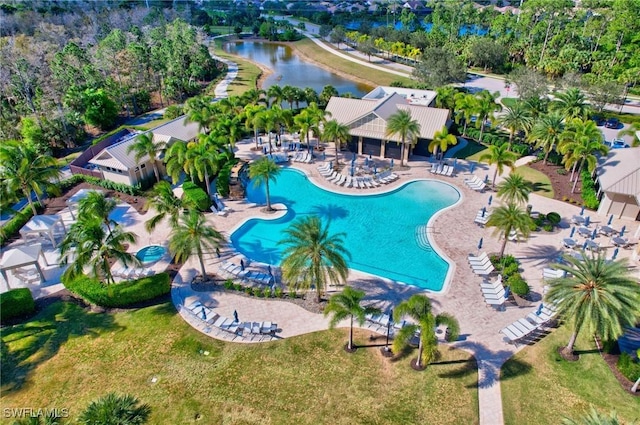 view of pool with a patio and a water view