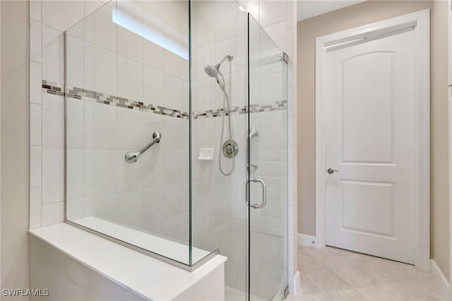 bathroom with tile patterned floors and walk in shower