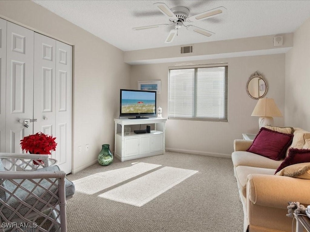 carpeted living room with ceiling fan