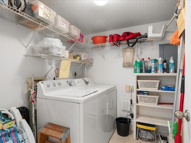 laundry area with separate washer and dryer and a textured ceiling