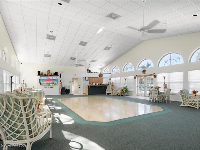 interior space with carpet flooring and ceiling fan