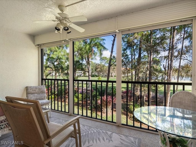 sunroom featuring ceiling fan