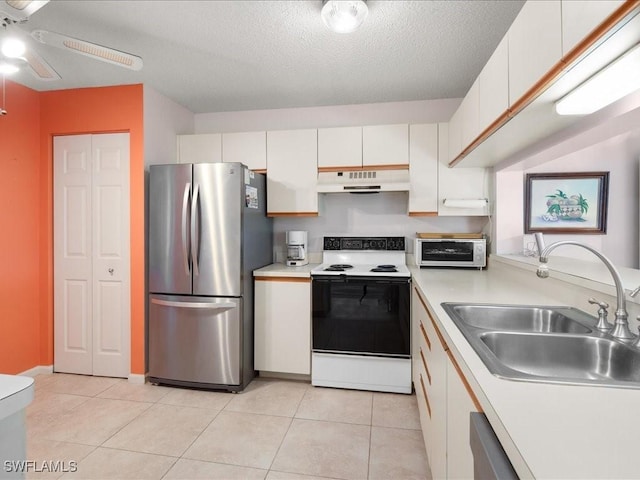 kitchen with white cabinets, sink, stainless steel fridge, a textured ceiling, and white electric range oven