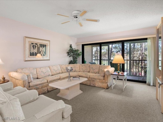 living room featuring carpet flooring, a textured ceiling, and ceiling fan