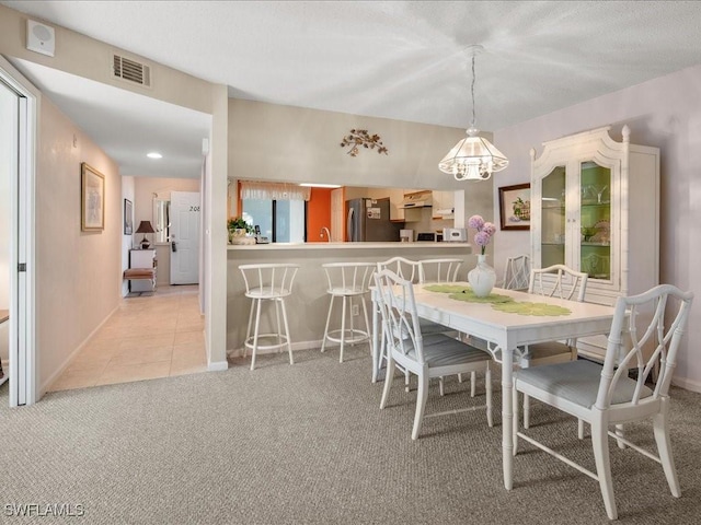 carpeted dining area featuring a wealth of natural light