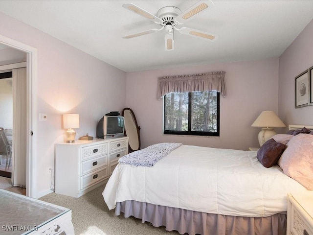 bedroom with ceiling fan and light carpet