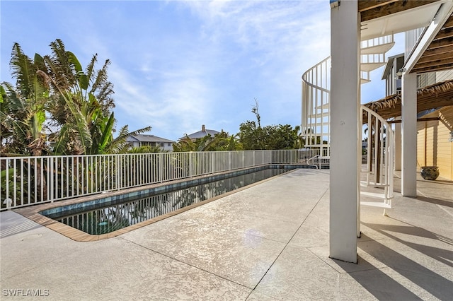 view of swimming pool with a patio