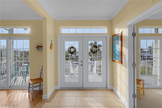 doorway featuring french doors, light hardwood / wood-style floors, and ornamental molding