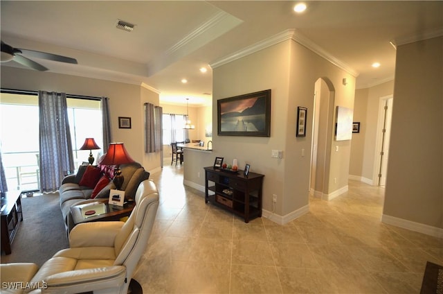 living room featuring ceiling fan, crown molding, and light tile patterned flooring