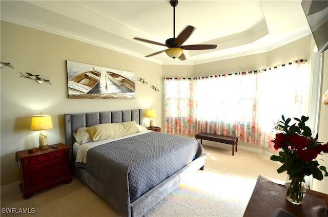 bedroom featuring carpet flooring, ceiling fan, a raised ceiling, and ornamental molding