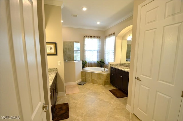 bathroom featuring tile patterned floors, vanity, crown molding, and tiled bath