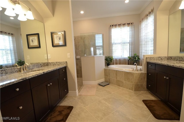 bathroom with tile patterned floors, plenty of natural light, ornamental molding, and vanity