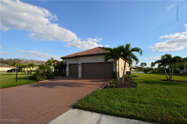 view of home's exterior featuring a lawn and a garage