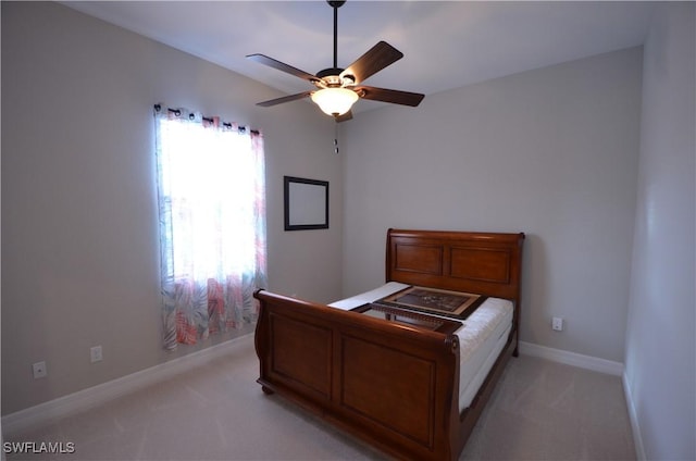 bedroom with ceiling fan and light colored carpet