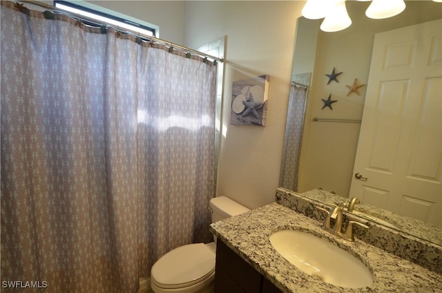 bathroom featuring vanity and toilet