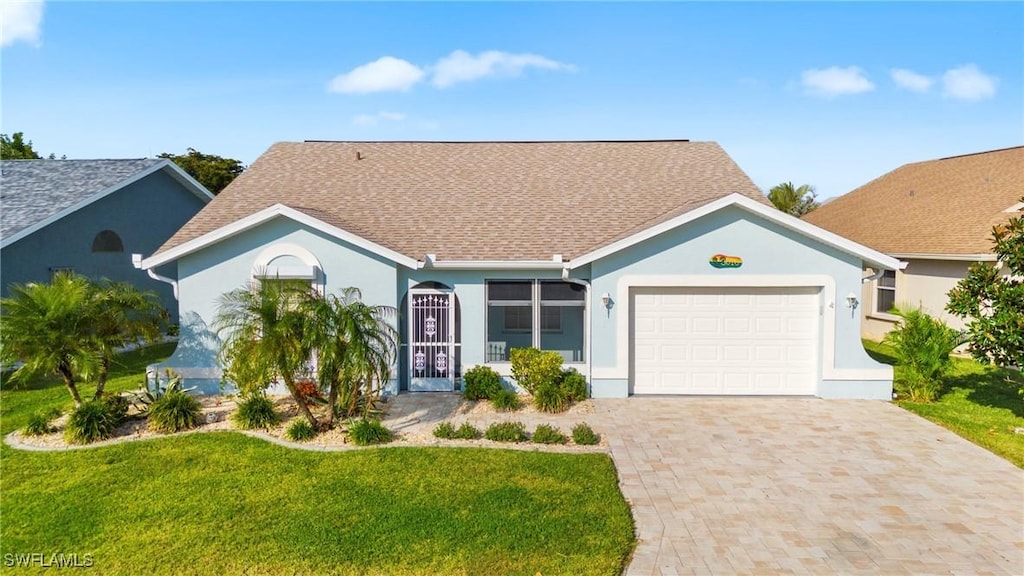 ranch-style house featuring a front yard and a garage