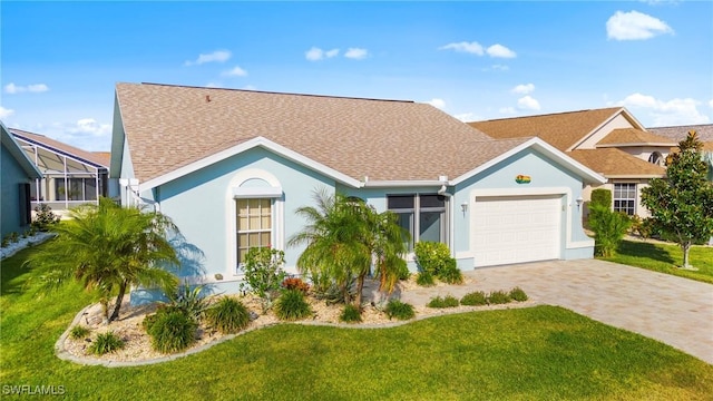 ranch-style house featuring a front yard and a garage