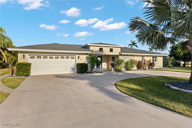 view of front of home with a front yard and a garage