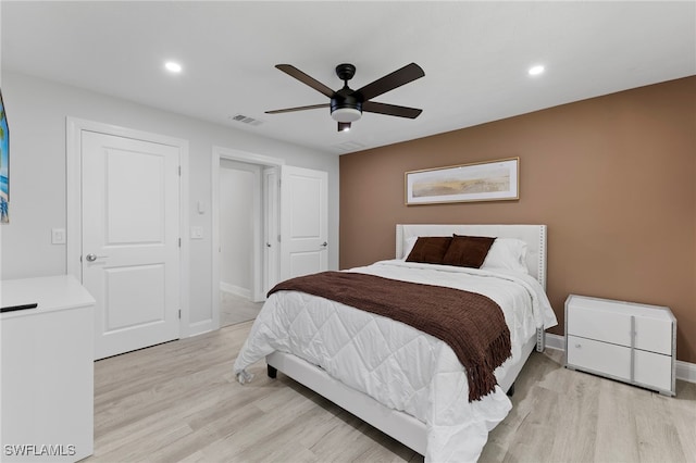 bedroom with ceiling fan and light hardwood / wood-style floors