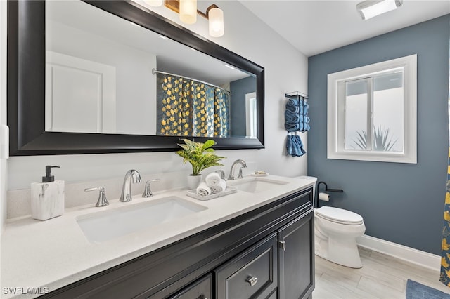 bathroom featuring hardwood / wood-style floors, toilet, and vanity