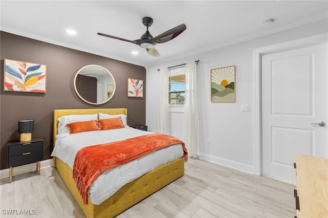 bedroom featuring light wood-type flooring, ceiling fan, and crown molding