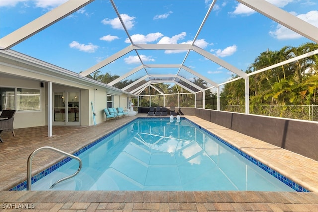 view of pool with a lanai, an outdoor living space, and a patio