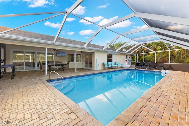 view of pool featuring glass enclosure and a patio