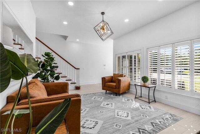 living room with recessed lighting, baseboards, light wood finished floors, and stairs