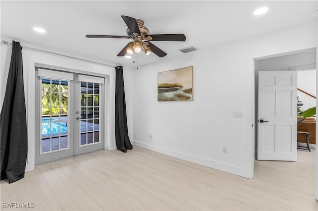 unfurnished room with visible vents, baseboards, french doors, light wood-type flooring, and recessed lighting