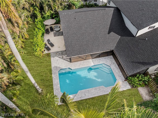 view of pool featuring a patio and a lawn