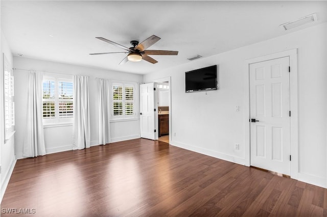 unfurnished living room with dark wood-style floors, ceiling fan, visible vents, and baseboards