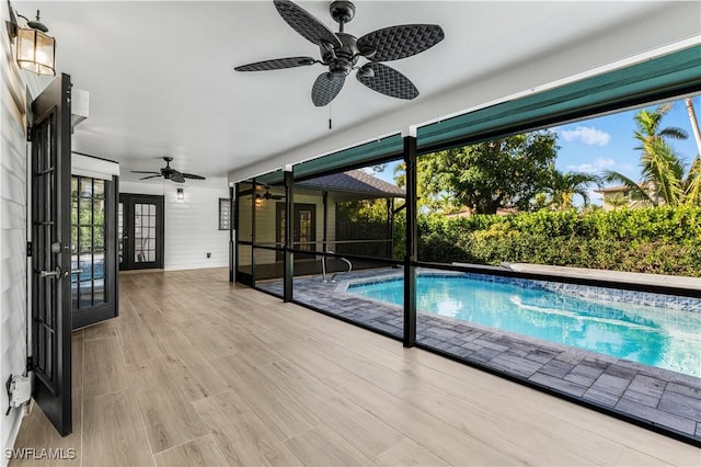 view of swimming pool featuring a fenced in pool, french doors, and ceiling fan