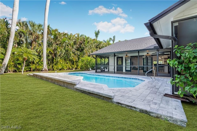 pool featuring a patio area, ceiling fan, and a yard