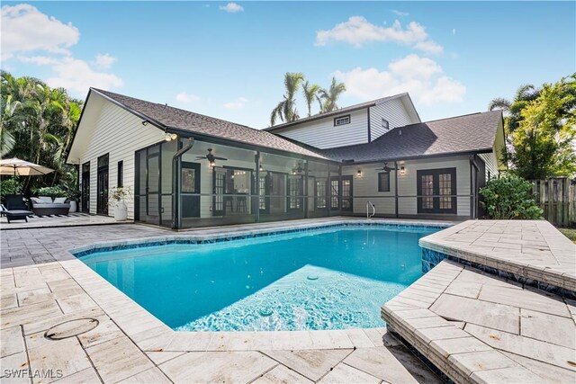 view of pool featuring french doors, a fenced in pool, a ceiling fan, fence, and a patio