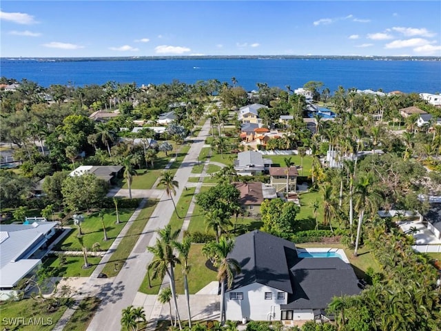 birds eye view of property with a water view and a residential view