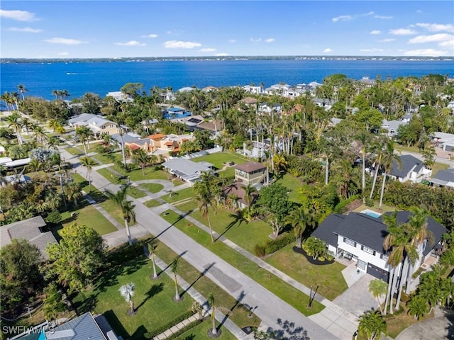 drone / aerial view with a residential view and a water view