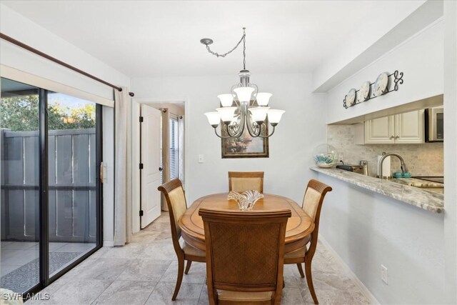 dining room with an inviting chandelier and sink